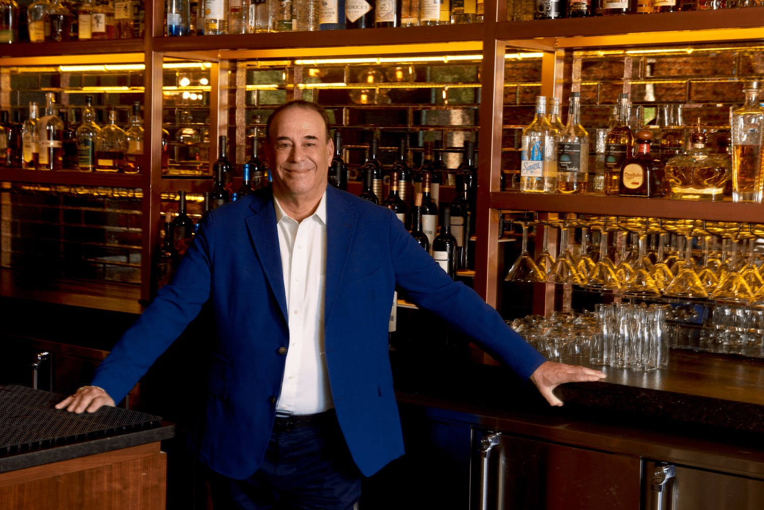 bar rescue star jon taffer standing in front of a bar at his Taffer's Tavern franchise