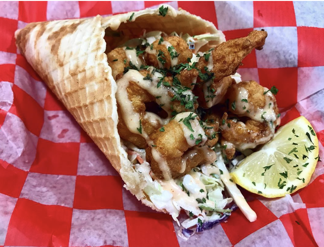 Waffle cone with fried seafood, sauce and a lime