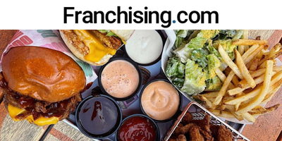 Franchising.com in black lettering, above shot angle of sauces, burger and salad