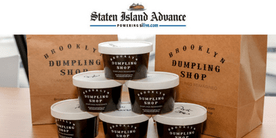 Staten Island Advance above stacks of Brooklyn Dumpling Shop food containers 