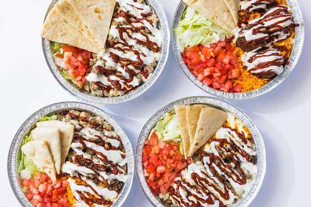 Four tasty plates of food from Halal Guys