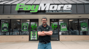 A photo of Dan Lowe in front of PayMore Electronics franchise store front